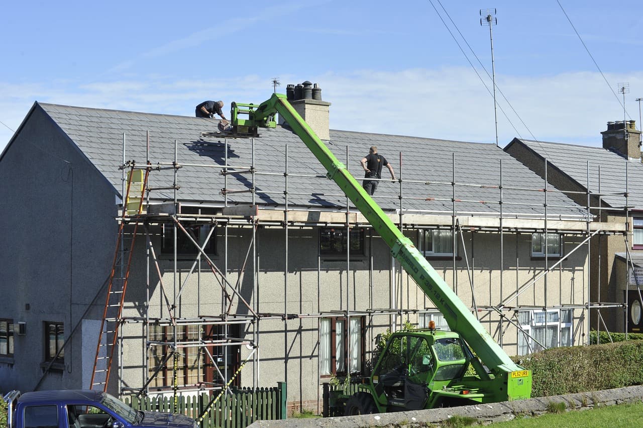 Scaffolding up for a re-roof on a row of slate-roofed houses
