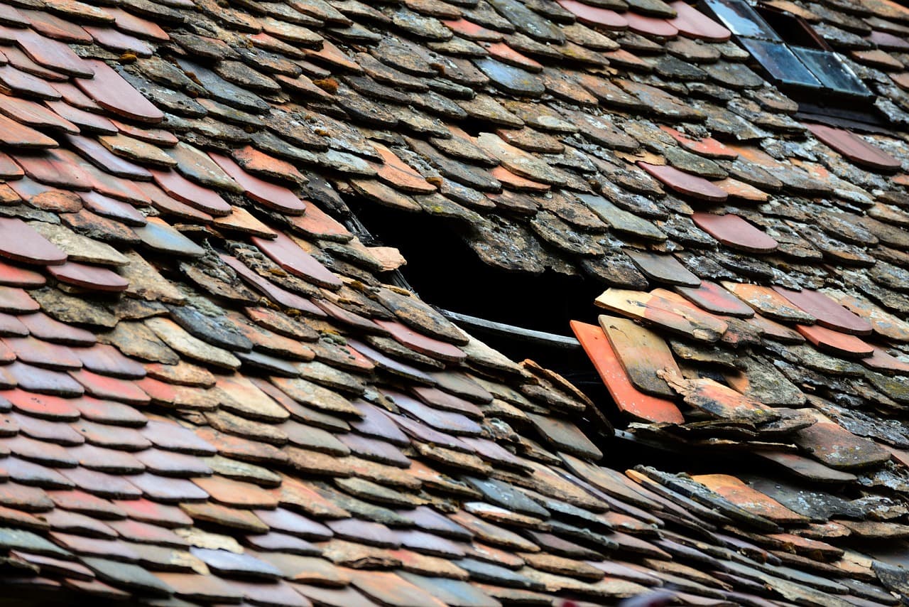 Hole in a tiled roof where tiles have slipped
